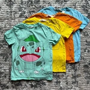 Lot of Four original  POKÉMON T-shirts Pikachu, Bulbasaur, Charmander + Squirtle